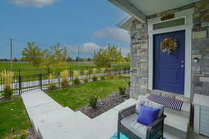 View of exterior entry featuring stone siding