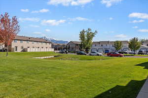 View of community featuring a residential view, a mountain view, and a lawn