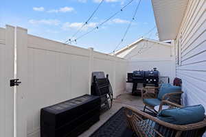 Fenced backyard featuring a patio and grilling area