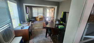 Dining space featuring dark wood-style flooring and cooling unit