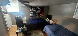 Bedroom featuring wood finished floors and baseboards