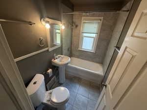 Bathroom featuring tile patterned flooring and shower / washtub combination