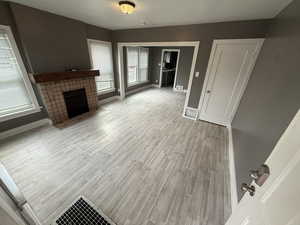 Unfurnished living room with a fireplace and light wood finished floors