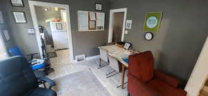 Office area featuring light wood-style floors and baseboards