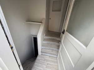 Stairs featuring wood finished floors