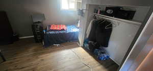 Bedroom with baseboards and wood finished floors