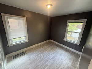 Spare room with light wood-style flooring and baseboards