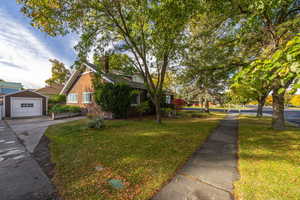 View of side of property featuring a yard,detached garage.