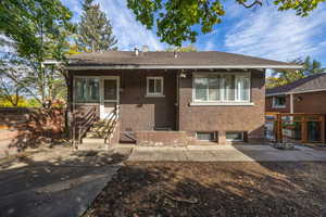 View of back of property with basement entrance.