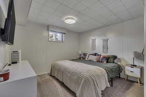 Carpeted bedroom featuring baseboards