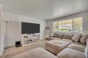 Living area featuring wood finished floors and wood walls