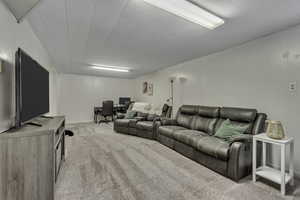 Carpeted living room featuring an office area