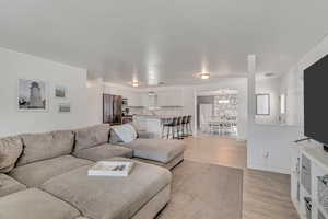 Living area with light wood-style flooring and baseboards