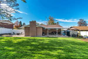 Back of property with a patio area, brick siding, and a fenced backyard