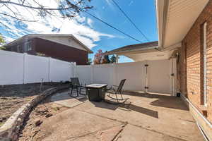 Fenced backyard featuring a patio area and an outdoor fire pit