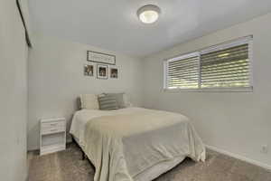 Carpeted bedroom with baseboards