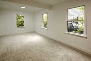 Unfurnished room with baseboards and carpet