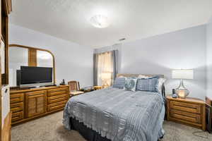 Bedroom 2 featuring carpet flooring and a textured ceiling