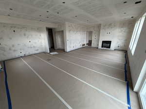 Unfurnished living room featuring a glass covered fireplace
