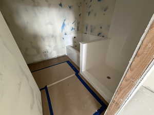 Bathroom featuring a bath and wallpapered walls