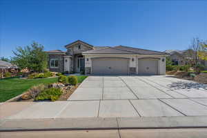 View of front of home featuring stone siding, stucco siding, an attached garage, concrete driveway, and a tiled roof
