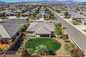 Aerial view of property and surrounding area featuring a mountain backdrop