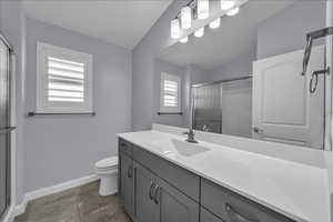 Full bathroom featuring a stall shower and vanity