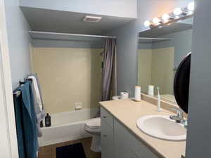 Full bath featuring shower / bathtub combination with curtain, vanity, and dark tile patterned floors