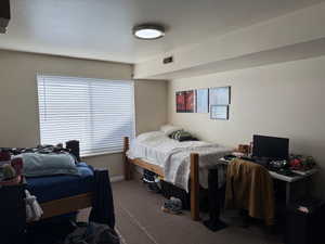 Carpeted bedroom with baseboards