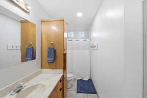Bathroom featuring vanity, light tile patterned floors, and recessed lighting