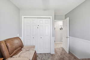 Sitting room with carpet floors and a textured ceiling