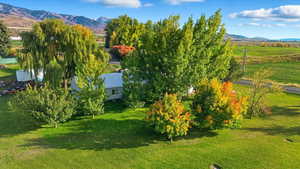 Aerial view of property and surrounding area with a mountain backdrop