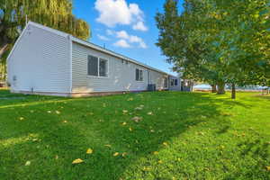 Rear view of property with a lawn