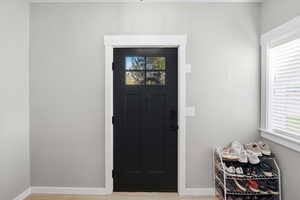 Entryway with healthy amount of natural light and light wood-style floors