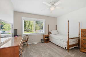 Bedroom with light carpet and ceiling fan