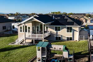 Rear view of house with a residential view, stucco siding, a deck, and solar panels