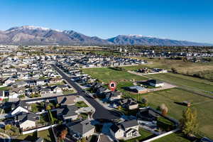 Aerial view of property's location with nearby suburban area and a mountainous background