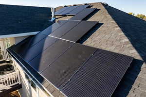 Exterior view of a shingled roof and Solar Panels