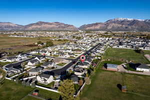 Aerial overview of property's location featuring nearby suburban area and mountains