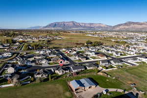 Aerial overview of property's location with nearby suburban area and a mountain backdrop