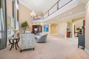 Building lobby featuring crown molding, a towering ceiling, and recessed lighting