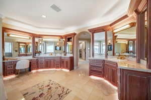 Full bath with crown molding, two vanities, healthy amount of natural light, recessed lighting, and light tile patterned flooring
