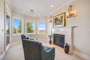 Living area featuring ornamental molding, light carpet, a high end fireplace, and recessed lighting
