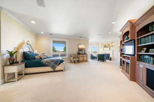 Bedroom featuring ornamental molding, light carpet, and recessed lighting