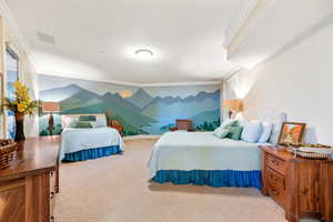 Carpeted bedroom featuring crown molding