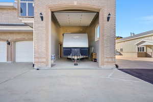 Entrance to property featuring brick siding and a garage