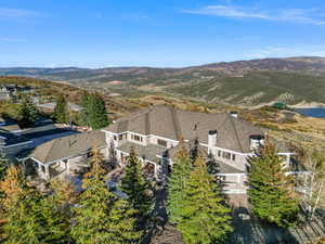Aerial view of property and surrounding area with mountains