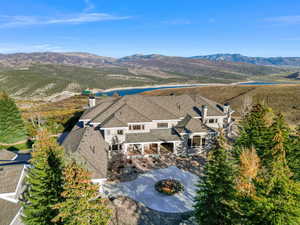 Aerial view of property and surrounding area with a water and mountain view