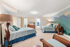 Bedroom with ornamental molding, carpet, and access to outside