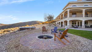 Patio / terrace with a patio, a mountain view, and an outdoor fire pit